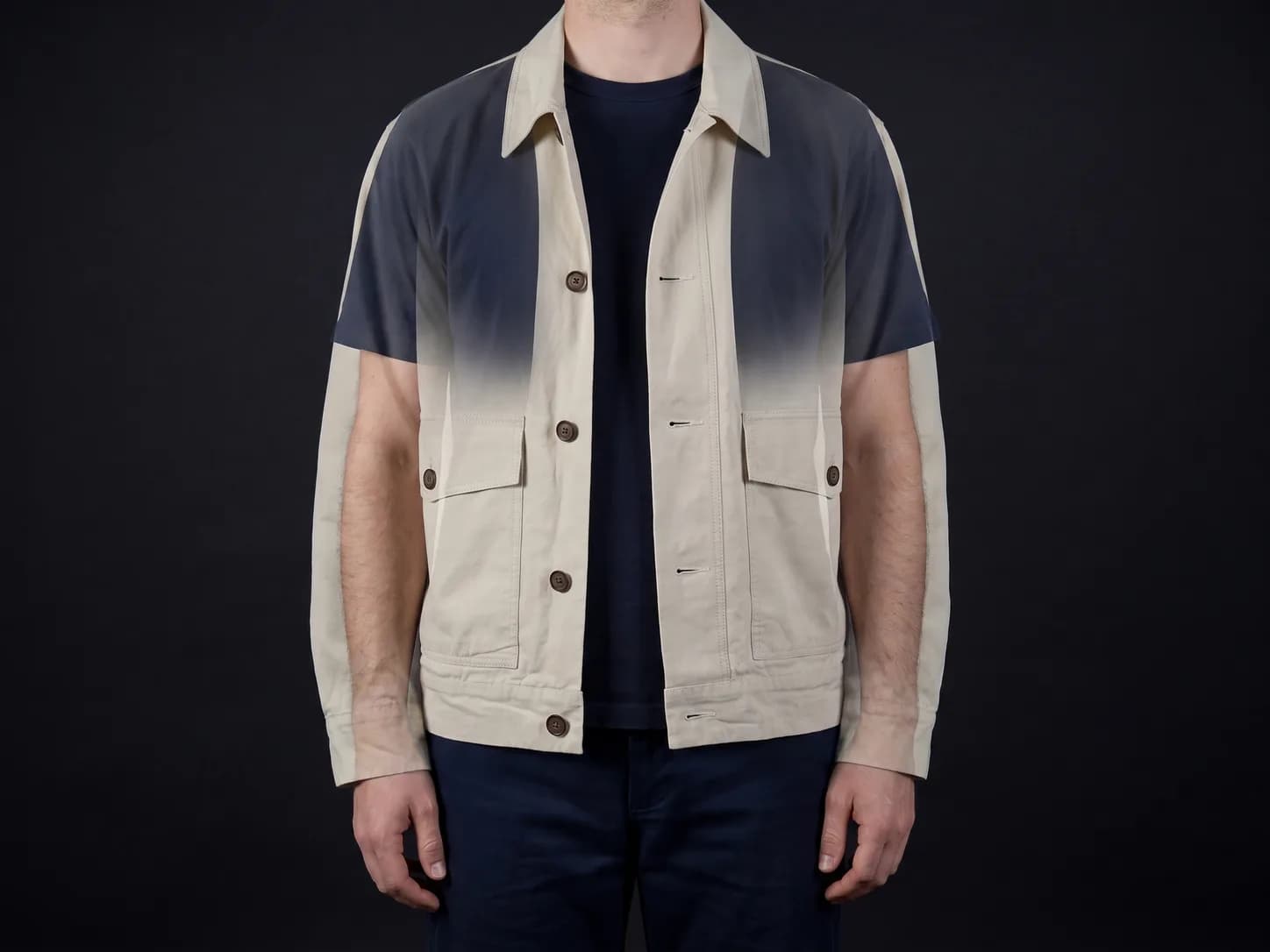 The same ecru jacket shown as a translucent overlay on a standing person, whose own navy t-shirt stays visible through it.